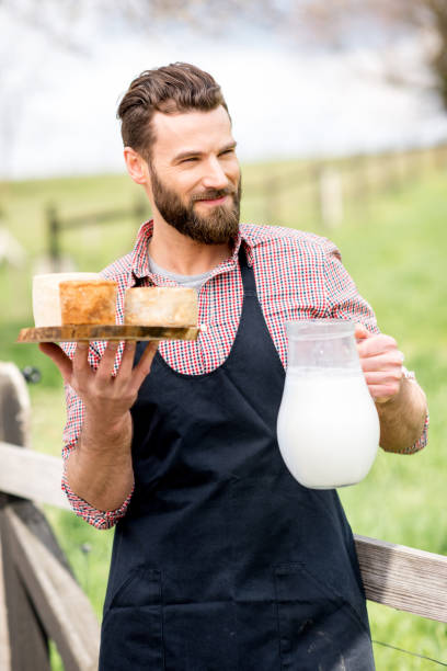 istock Farmer with cheese and milk 672369778