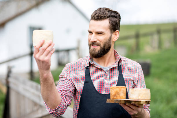 istock Farmer with cheese outdoors 672370088