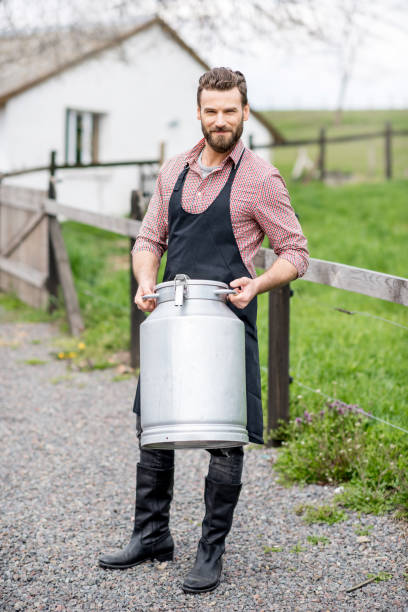 istock Farmer with milk outdoors 672372366