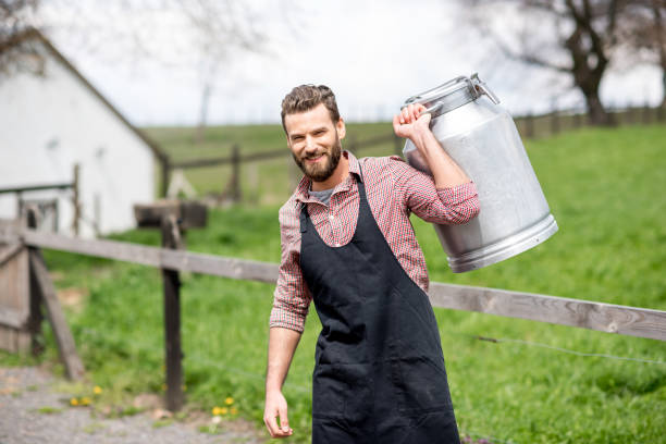 istock Farmer with milk outdoors 672372472