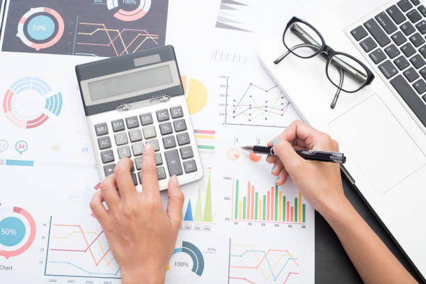 istock business accountant with document graph financial and calculator on office table. concept planning budget and audit. 672372534