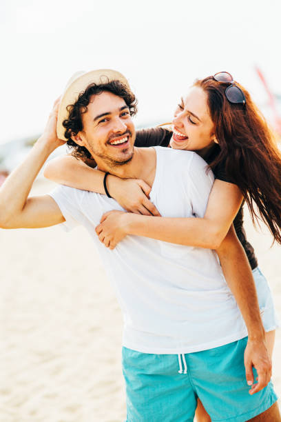 istock Young couple at the beach 672372826