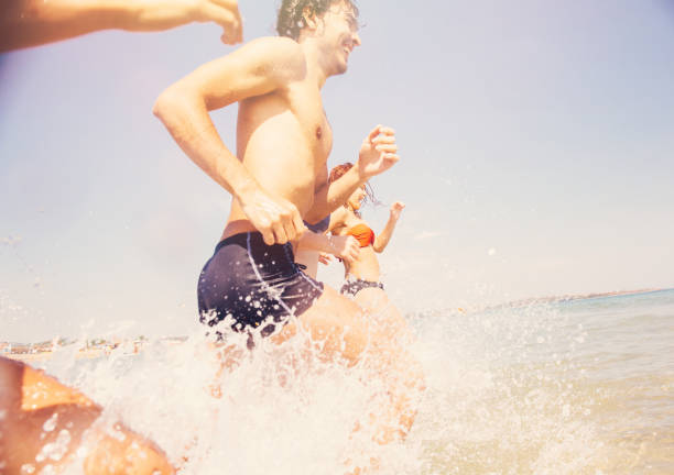 istock Friends going into the sea 672372866