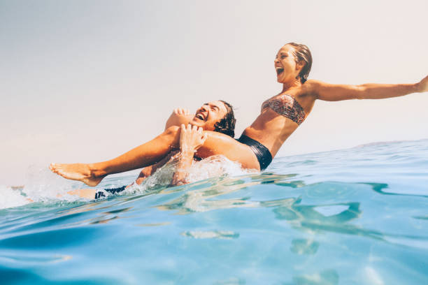 istock Couple having fun in the sea 672372868