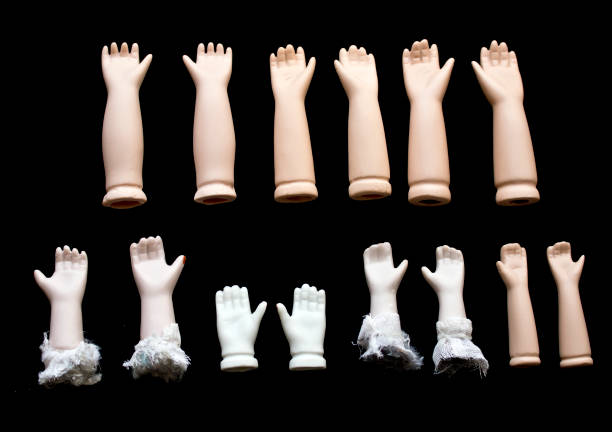 istock Broken Doll Hand and Arms on Black Background 672373426