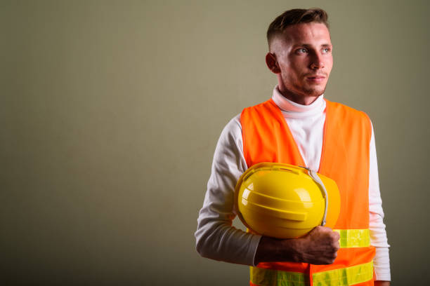 istock Studio shot of young man construction worker against colored background 672373588