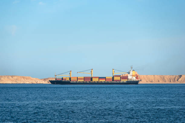 istock Container ship delivers cargo in containers near a uninhabited island 672374724