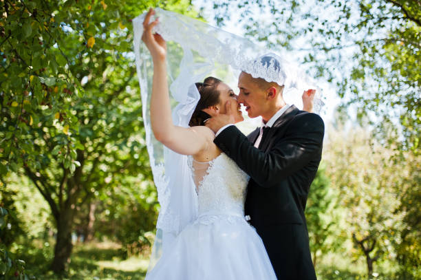 istock young happy wedding couple on the green park 672377680
