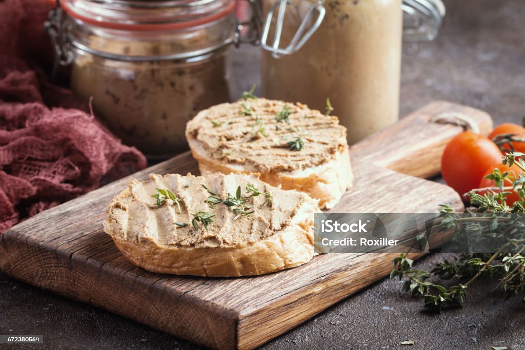 Fresh chicken liver pate Fresh homemade chicken liver pate on bread over rustic background Pate Stock Photo