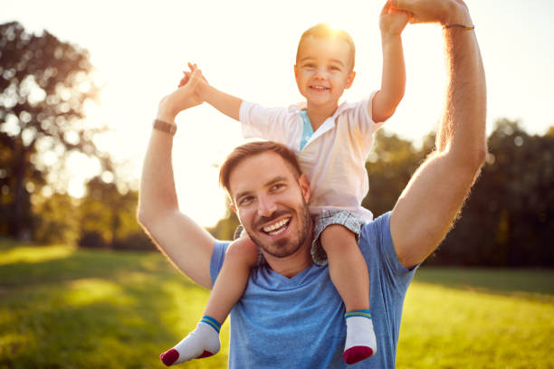 istock Happy father with son in park 672381032