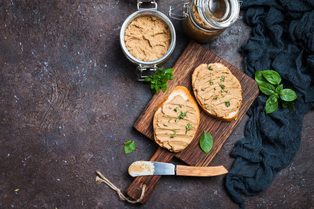 Fresh chicken liver pate Fresh homemade chicken liver pate on bread over rustic background, top view spread wings stock pictures, royalty-free photos & images