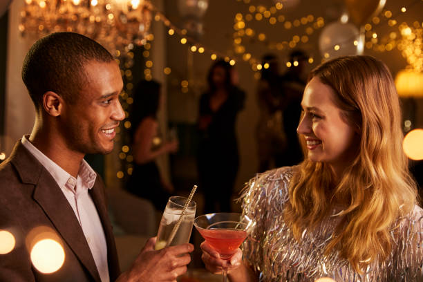 istock Couple Chat As They Enjoy Cocktail Party Together 672381192