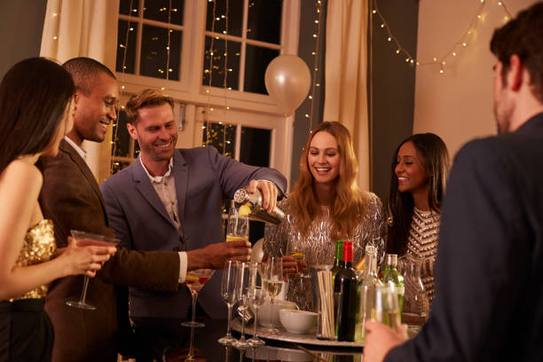 istock Man Making Cocktails For Friends At Party 672381536