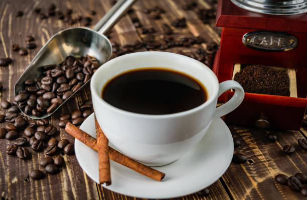 istock coffee cup old grinder top wooden close-up 672382848
