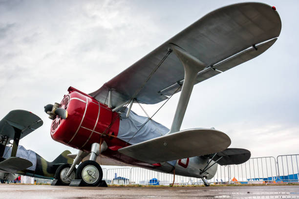 istock Retro biplanes in the parking lot under a little rain 672386282
