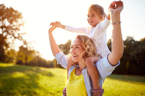 Happy young woman with child together outdoor