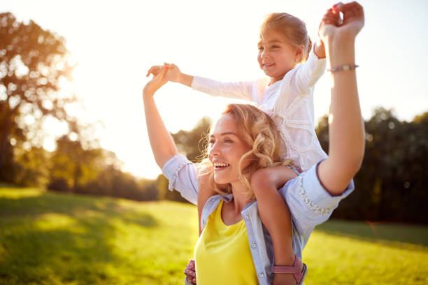 happy woman with child together outdoor - spring child green small imagens e fotografias de stock