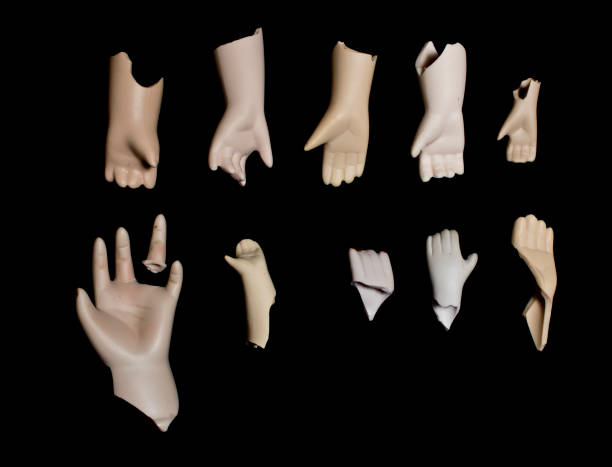 istock Broken Doll Hand and Arms on Black Background 672387056