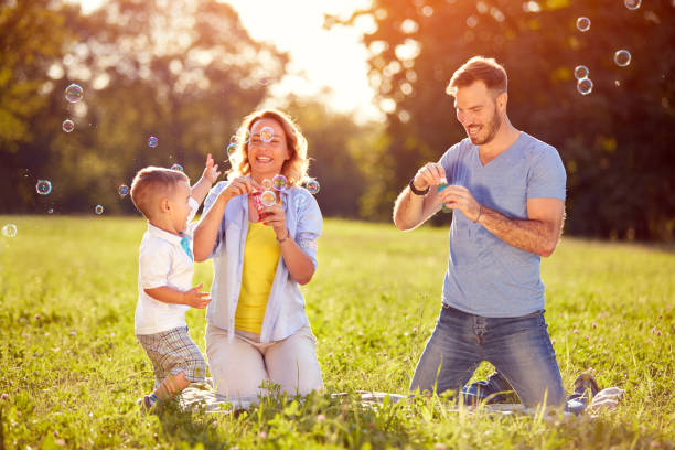 istock Children in nature having fun with soap bubbles 672389952