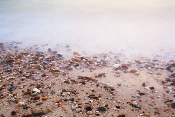 istock Beautiful beach sand background with pebbles. 672390778