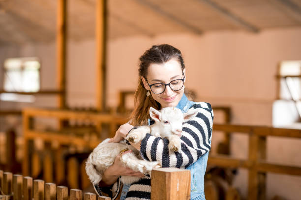 istock Woman with baby goat 672391654