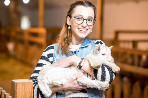istock Woman with baby goat 672391732