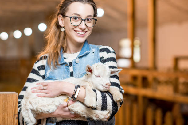 istock Woman with baby goat 672393994