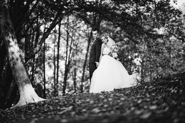 istock Young and gorgeous wedding couple on autumn forest 672394114