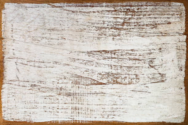 istock Distressed white wooden grained background with worn edges. 672398300