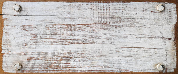 istock Distressed white wooden grained panel with four bolts, one in each corner. 672398396