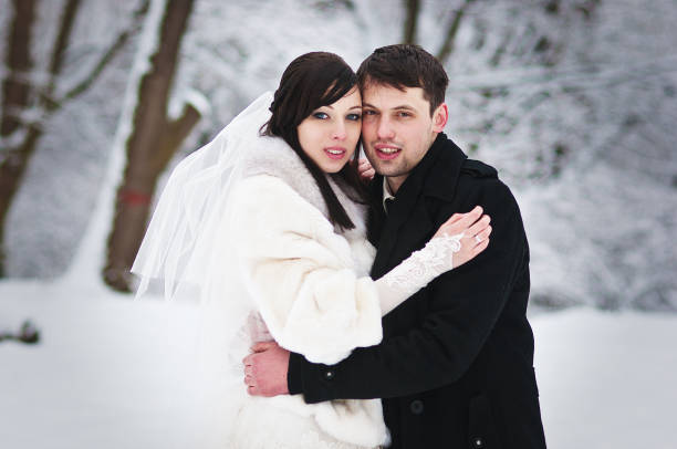istock Wedding couple in winter snowly forest 672398940