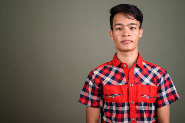 istock Studio shot of young Asian man against colored background 672402466