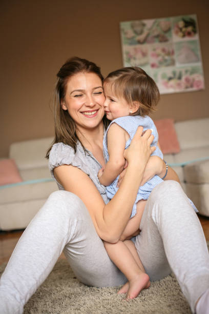 istock Mother and baby playing on the floor. 672411950