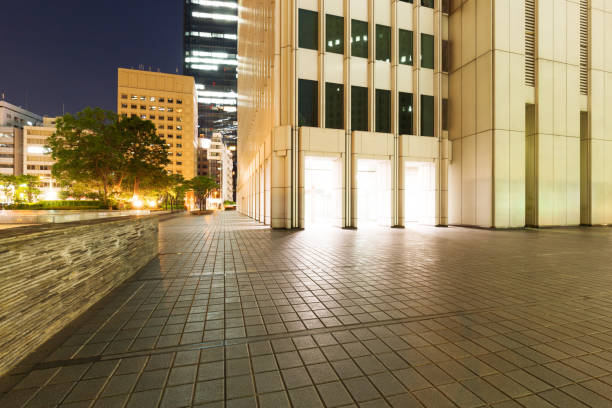 istock empty footpath outside of modern building at night 672412430