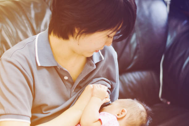 istock Baby feeds on  mother's breasts milk 672412586