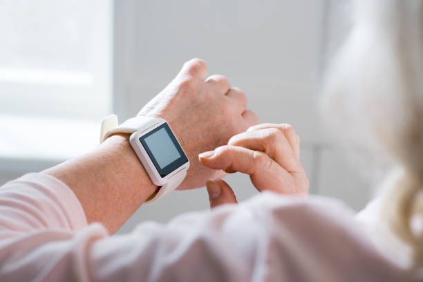 istock Senior woman with smartwatch 672415256
