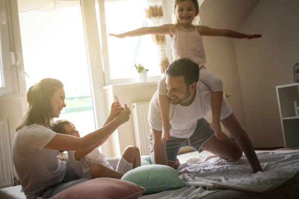 istock Happy family with two daughters at home. 672415934