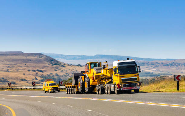istock Heavy Cargo on the Road transporting construction machinery 672418630