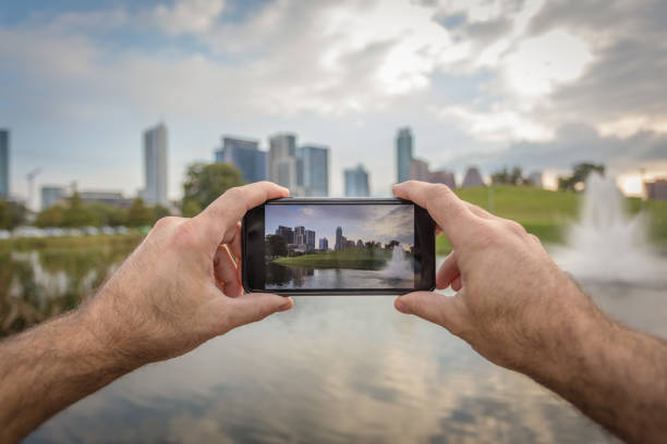 istock Human Hand Holding a Smart Phone in Austin Texas 672419528