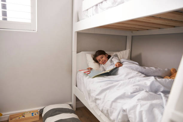 istock Girl Reading Story In Bunk Bed At Bedtime 672419624