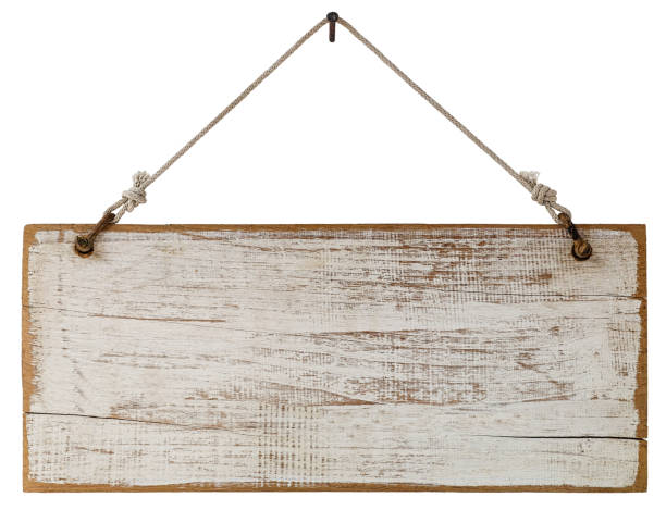 istock Old weathered worn white wooden sign panel, hanging by old rope from a rusty nail, isolated on white, clipping path included. 672422046