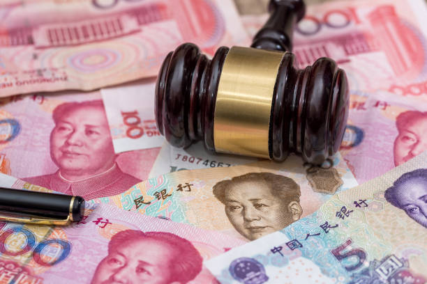 istock yuan on wooden hammer . close up. 672425736