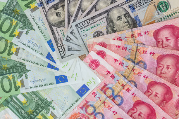 istock US dollar and Euro, yuan  banknotes as background 672426542