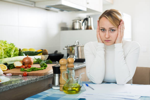 istock Upset woman calculating budget in kitchen 672432542