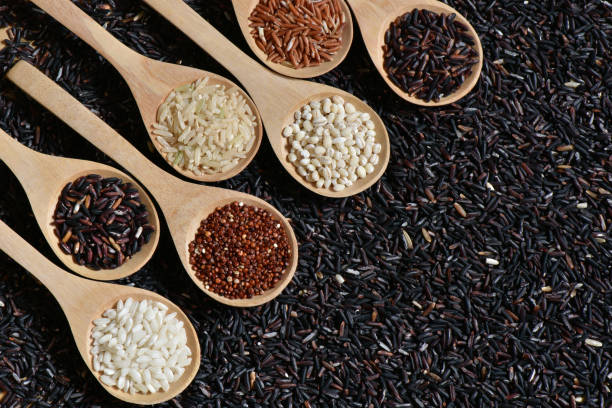 istock Collection rice on wooden spoon with riceberries background 672436088