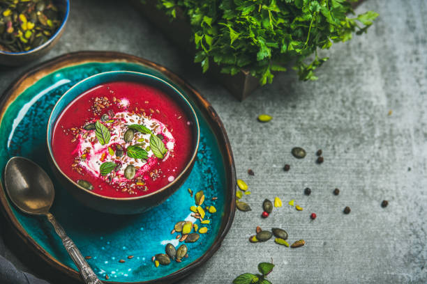 Spring beetroot soup with mint and seeds, copy space stock photo