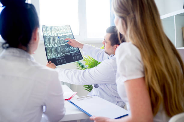 group of doctors looking at xray - dental light dental equipment hospital professional occupation imagens e fotografias de stock