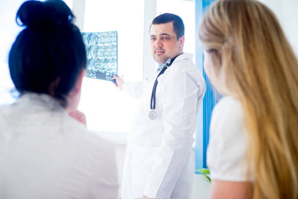 istock Group of doctors looking at xray 672446104