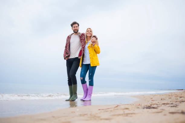 istock Couple walking at the beach 672449094