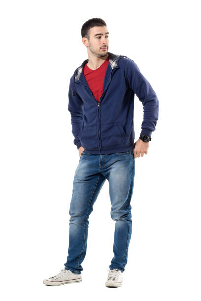 istock Relaxed young cool man in blue sweatshirt with hands in back pockets looking behind 672450056